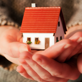 Woman-Holding-Small-New-House-Hands-Real-Estate-Mortgage
